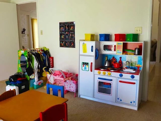 Dramatic-play kitchen and dress-up area at ABC Time